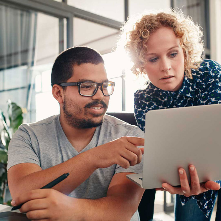 small business owners consulting over a computer screen